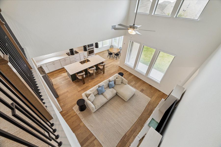 From the upstairs landing, enjoy a full view of the family room, kitchen, and bright breakfast nook below.