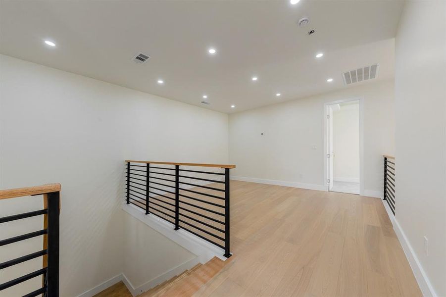 Corridor featuring recessed lighting, an upstairs landing, and light wood-style floors