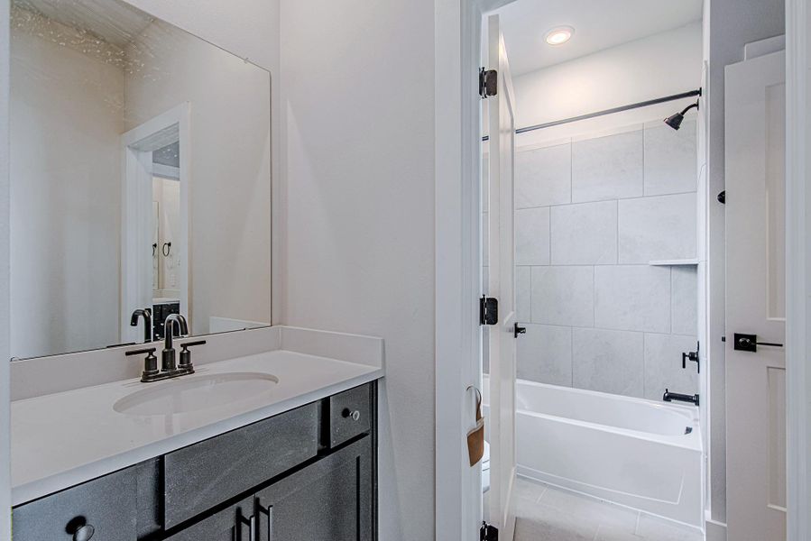 Full bathroom featuring modern fixtures and clean design Full bathroom featuring modern fixtures and clean design