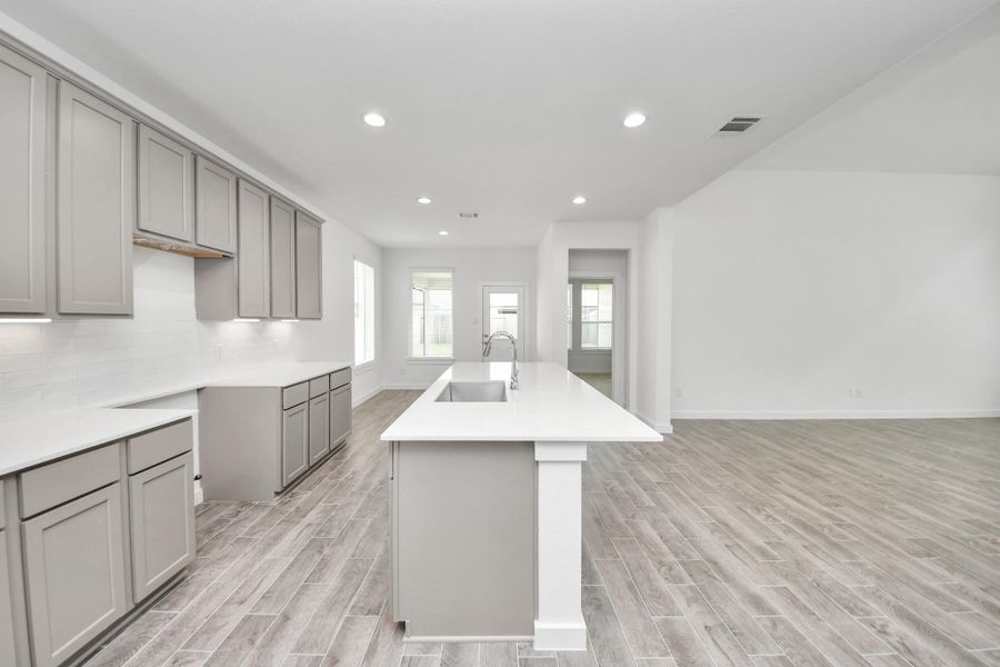 This kitchen is by far any chef’s dream! This spacious kitchen features high ceilings, light stained wood cabinets, granite countertop, SS appliances, modern tile backsplash, recessed lighting, extended counter space, granite kitchen island with double sink, and space for breakfast bar, and a walk-in pantry all overlooking your huge family room. Sample photo of completed home with similar floor plan. Actual colors and selections may vary. This kitchen is by far any chef’s dream! This spacious kitchen features high ceilings, light stained wood cabinets, granite countertop, SS appliances, modern tile backsplash, recessed lighting, extended counter space, granite kitchen island with double sink, and space for breakfast bar, and a walk-in pantry all overlooking your huge family room. Sample photo of completed home with similar floor plan. Actual colors and selections may vary.