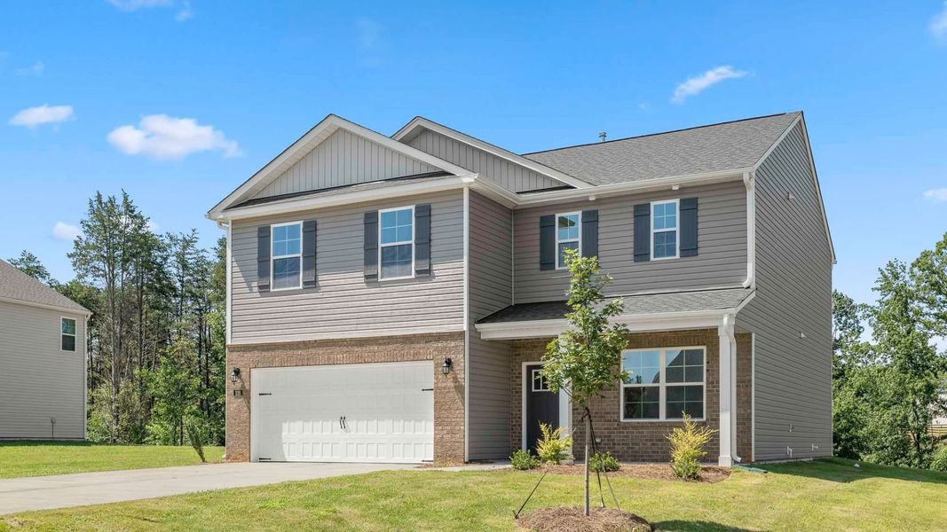 Front exterior of a new home in Forest Creek, Winston-Salem, NC, highlighting curb appeal (Image 2). Front exterior of a new home in Forest Creek, Winston-Salem, NC, highlighting curb appeal (Image 2).