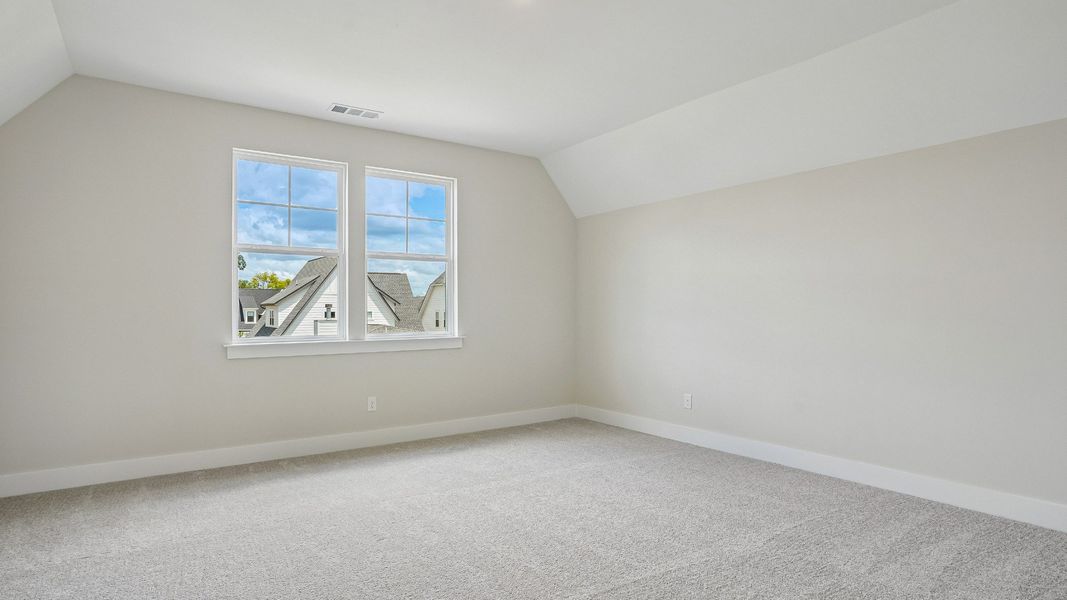 Guest bedroom with vaulted ceiling
