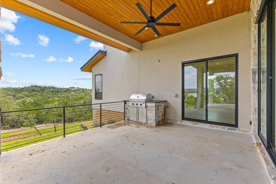 An outdoor covered patio offers scenic views and a built-in barbecue for al fresco dining. An outdoor covered patio offers scenic views and a built-in barbecue for al fresco dining.