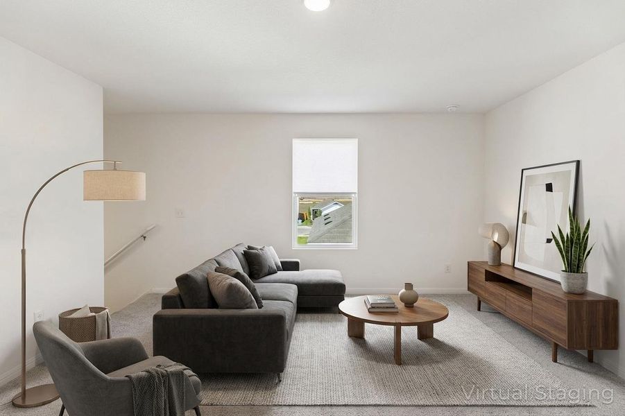 Carpeted living room with baseboards