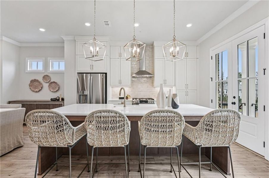 Kitchen featuring healthy amount of natural light and plenty of storage and seating