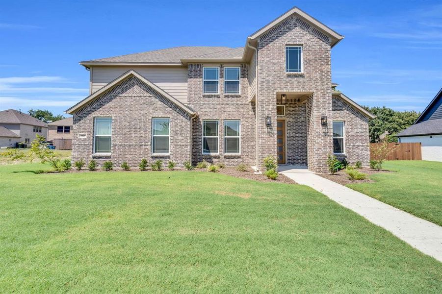 Front exterior of a new home in Ten Mile Creek Estates, DeSoto, TX, highlighting curb appeal (Image 19). Front exterior of a new home in Ten Mile Creek Estates, DeSoto, TX, highlighting curb appeal (Image 19).