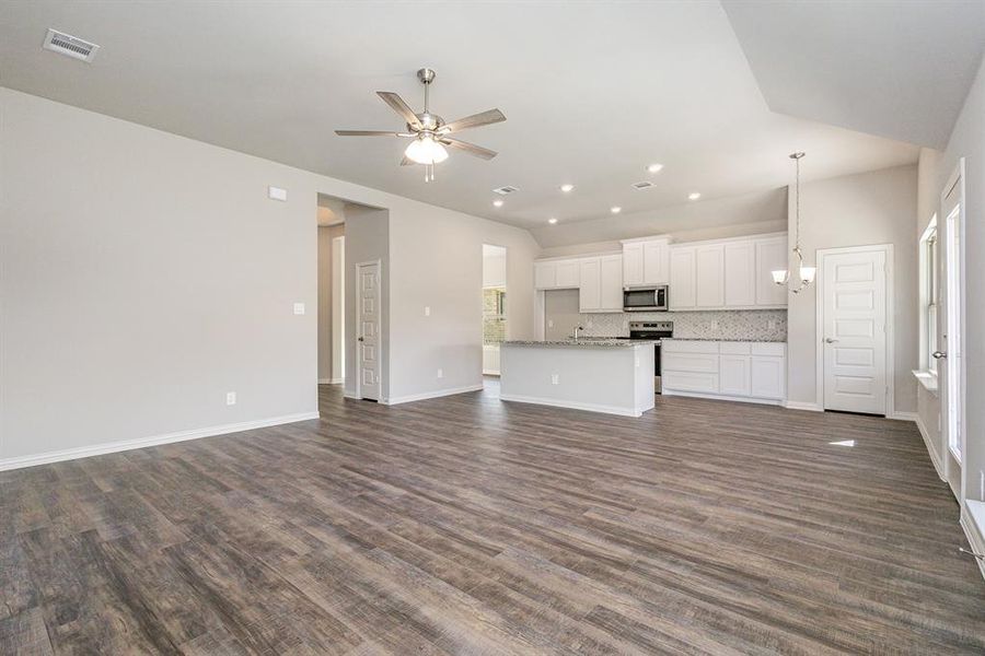 Unfurnished living room featuring ceiling fan, dark hardwood / wood-style flooring, and sink