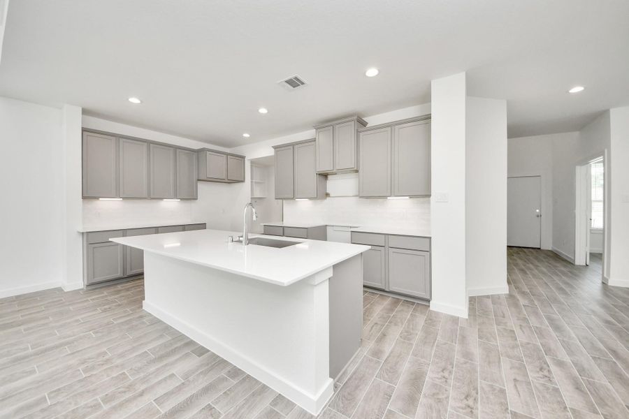 This kitchen is by far any chef’s dream! This spacious kitchen features high ceilings, light stained wood cabinets, granite countertop, SS appliances, modern tile backsplash, recessed lighting, extended counter space, granite kitchen island, and space for breakfast bar, and a walk-in pantry all overlooking your huge family room. This kitchen is by far any chef’s dream! This spacious kitchen features high ceilings, light stained wood cabinets, granite countertop, SS appliances, modern tile backsplash, recessed lighting, extended counter space, granite kitchen island, and space for breakfast bar, and a walk-in pantry all overlooking your huge family room.