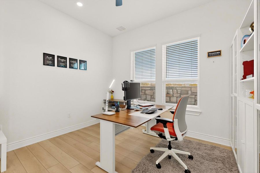 Office space featuring light wood finished floors, ceiling fan, and recessed lighting