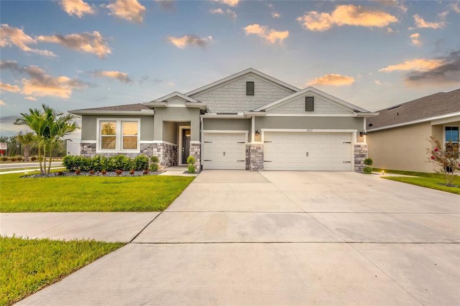 Front exterior of a new home in Harmony West, Harmony, FL, highlighting curb appeal (Image 2). Front exterior of a new home in Harmony West, Harmony, FL, highlighting curb appeal (Image 2).
