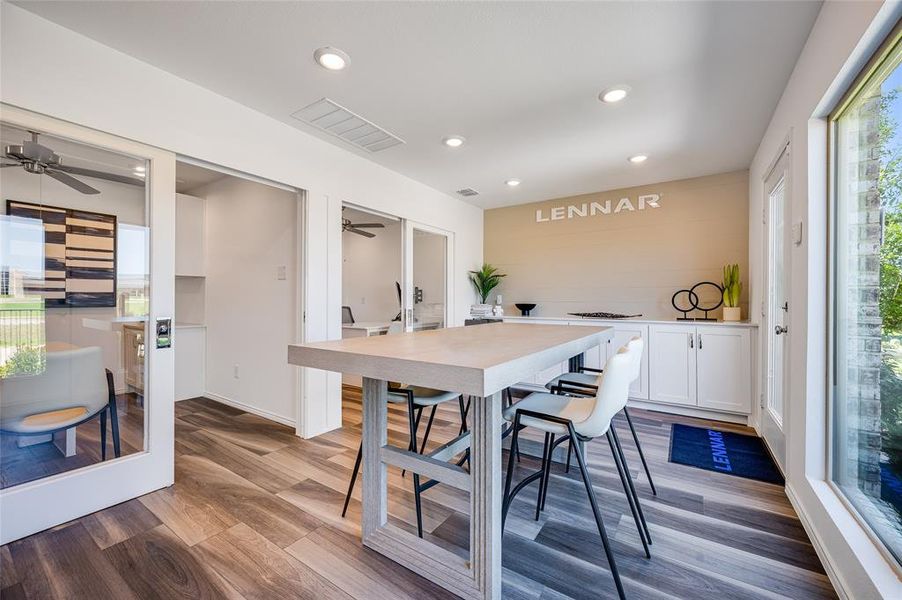 Dining room with ceiling fan, wood-type flooring, and a wealth of natural light