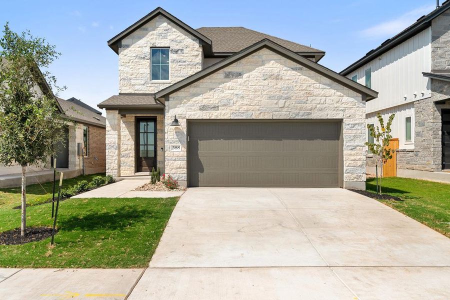 Front exterior of a new home in Terrace Collection at Heritage, Dripping Springs, TX, highlighting curb appeal (Image 1). Front exterior of a new home in Terrace Collection at Heritage, Dripping Springs, TX, highlighting curb appeal (Image 1).