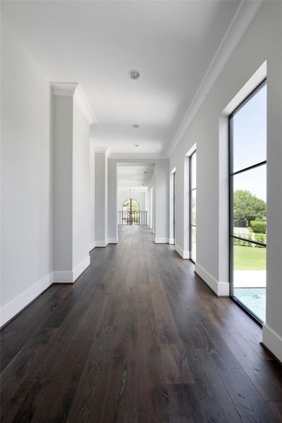 Light-filled 2nd floor hallway with views of pool and neighborhood.