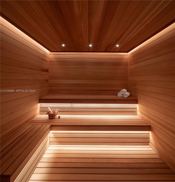 Custom-built sauna featuring tongue-and-groove wood paneling, multi-level tiered benches, recessed ceiling lighting, and integrated linear LED accent illumination