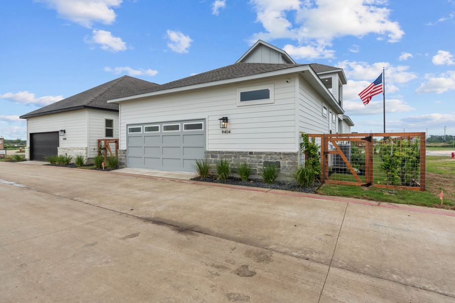 Front exterior of a new home in The Crossvine – Garden Homes, Schertz, TX, highlighting curb appeal (Image 19).