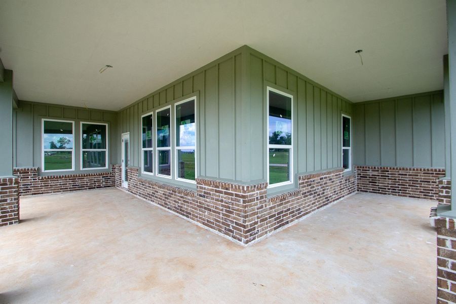 Spacious covered patio with a combination of brick and siding, offering a perfect space for outdoor relaxation and entertainment. Spacious covered patio with a combination of brick and siding, offering a perfect space for outdoor relaxation and entertainment.