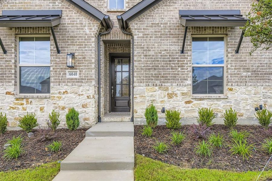 Entrance to property with stone siding and brick siding Entrance to property with stone siding and brick siding