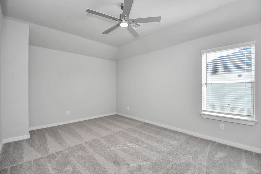 Secondary bedroom features plush carpeting, large windows that let in plenty of natural light, bright paint, and spacious closets.