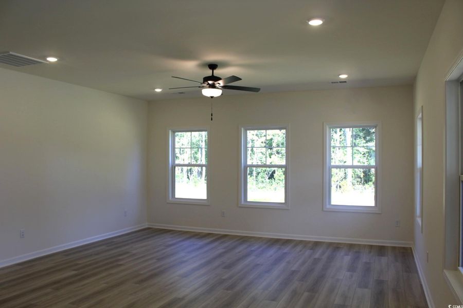 Spare room featuring dark wood-style flooring, recessed lighting, and a ceiling fan Spare room featuring dark wood-style flooring, recessed lighting, and a ceiling fan