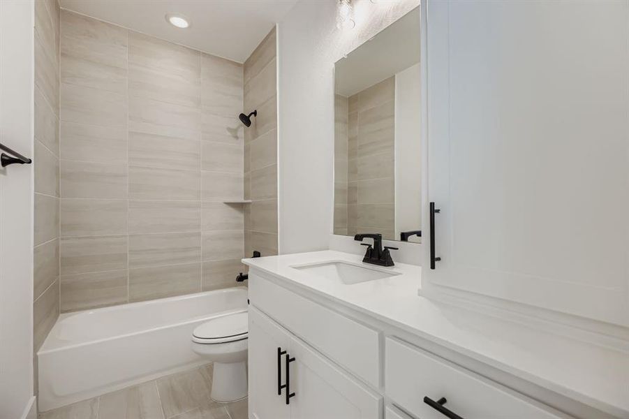 Full bathroom with vanity, shower / washtub combination, and recessed lighting Full bathroom with vanity, shower / washtub combination, and recessed lighting