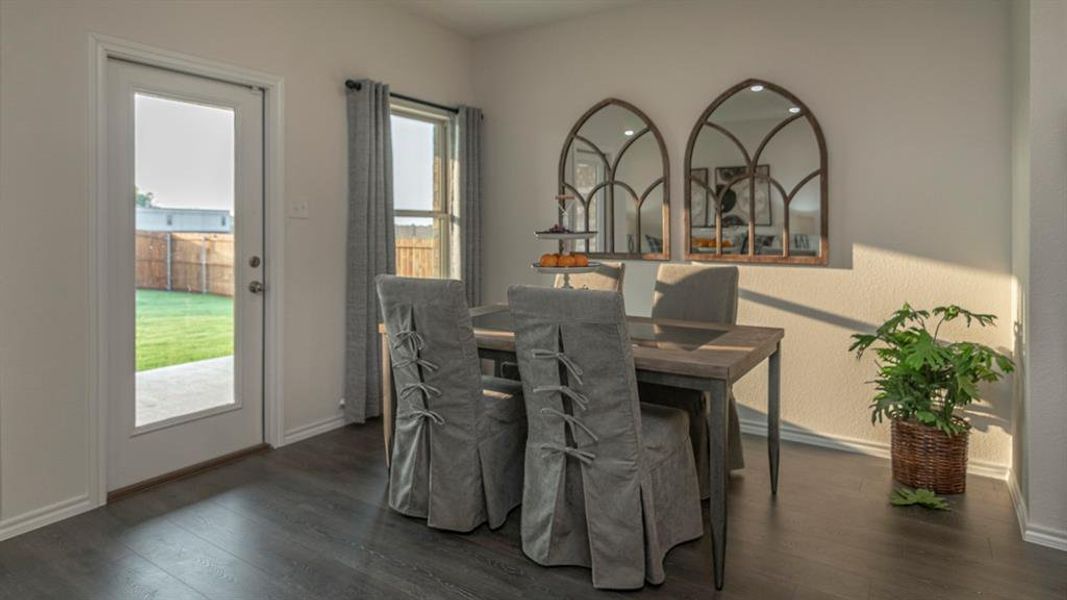 Dining area featuring wood-finish flooring, white baseboards, and light-colored walls