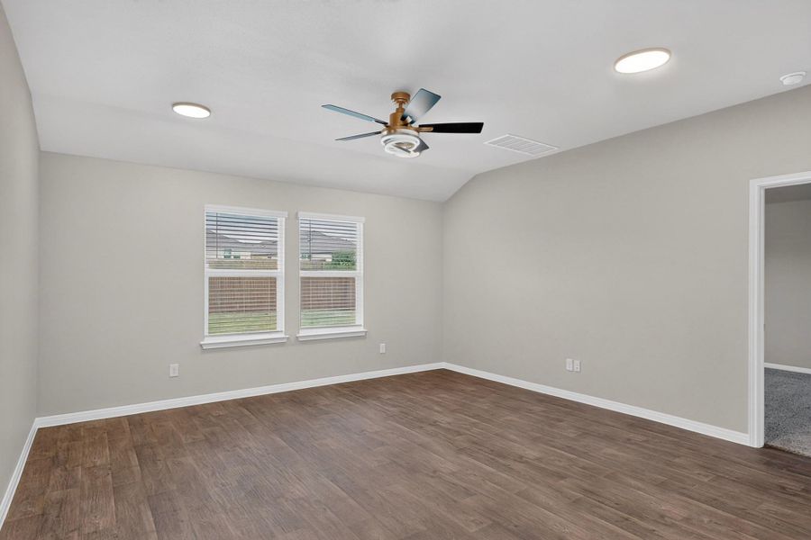 Rich wood-look flooring and vaulting details create a welcoming atmosphere in this versatile space.