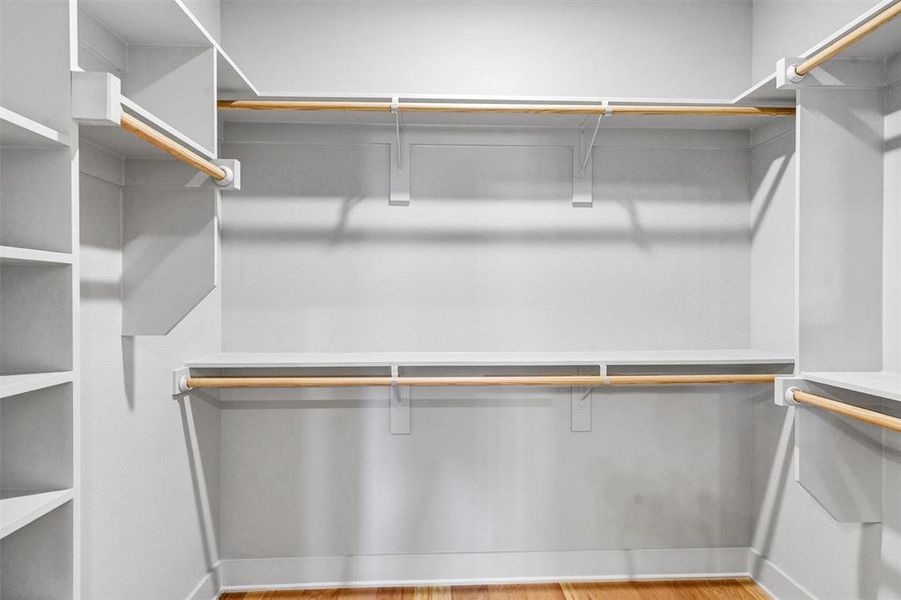 Walk in closet with light wood-style flooring