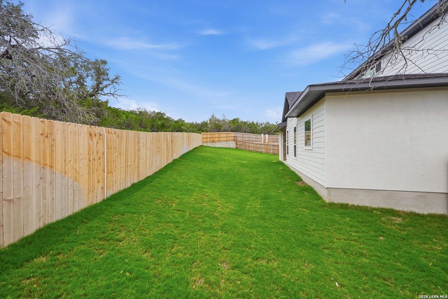 Exterior details and patio area of a home in The Reserve at Potranco Oaks, Castroville (Image 28).