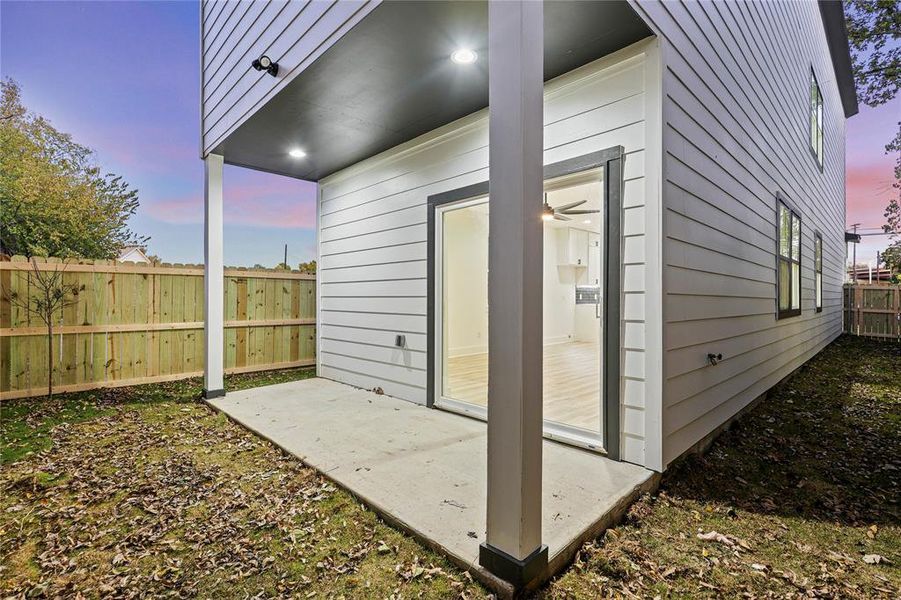 Property exterior at dusk with a patio area