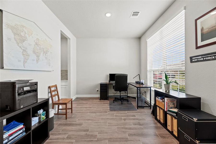 Immediately to the right of the entry awaits your spacious Dining Room, offering seamless access to the Butler's Pantry and Kitchen. Currently serving as a versatile second home office.