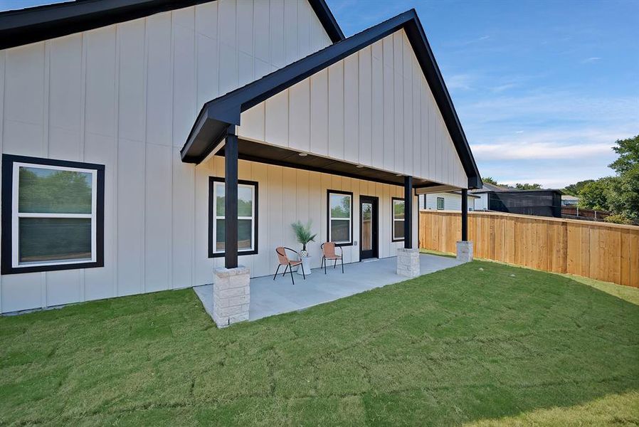 Back of property featuring covered porch and board and batten siding Back of property featuring covered porch and board and batten siding