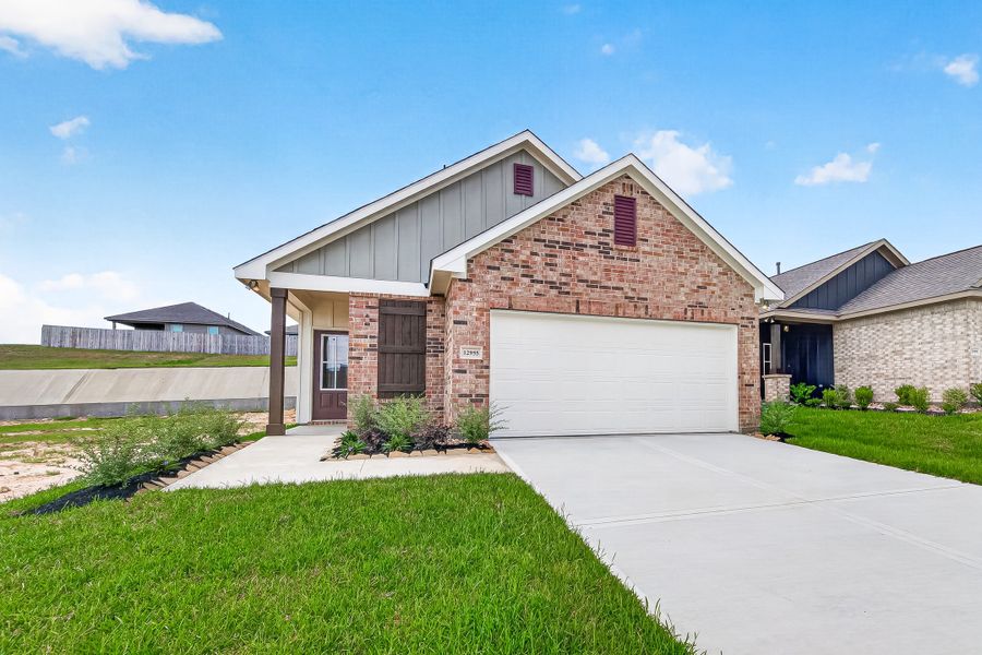 Front exterior of a new home in Mostyn Springs, Magnolia, TX, highlighting curb appeal (Image 2). Front exterior of a new home in Mostyn Springs, Magnolia, TX, highlighting curb appeal (Image 2).