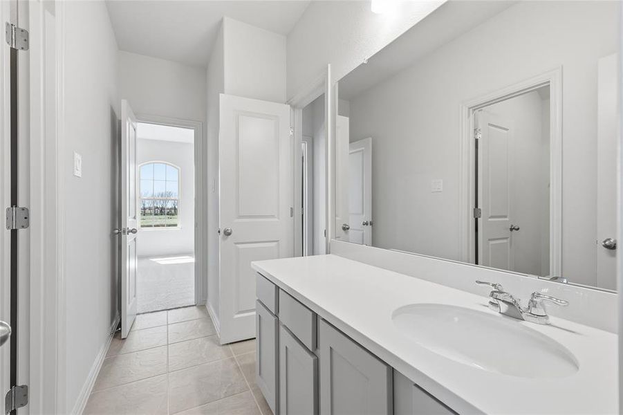Bathroom vanity with light gray cabinetry, a white countertop, and a rectangular undermount sink