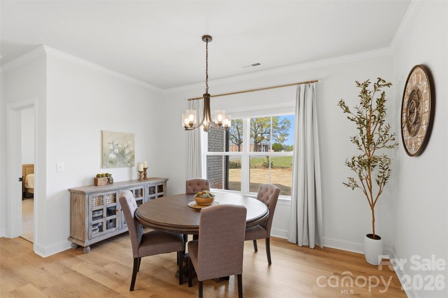 Sunlit dining area with a cozy, intimate setting perfect for everyday meals and gatherings.