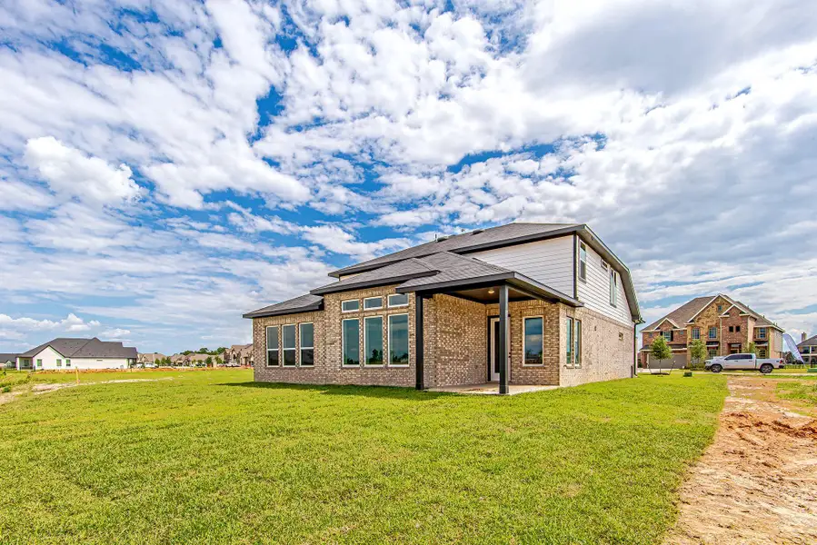 Expansive backyard with a generous covered patio—ideal for outdoor dining, entertaining, or simply relaxing under wide-open Texas skies.