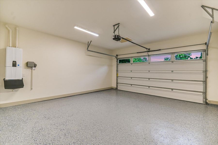 A pristine, well-lit garage awaits, featuring a durable epoxy floor, single overhead door equipped w/ an automatic opener and with transom windows for natural lighting. Efficient tankless water heater to make sure you never run out of hot water! A pristine, well-lit garage awaits, featuring a durable epoxy floor, single overhead door equipped w/ an automatic opener and with transom windows for natural lighting. Efficient tankless water heater to make sure you never run out of hot water!