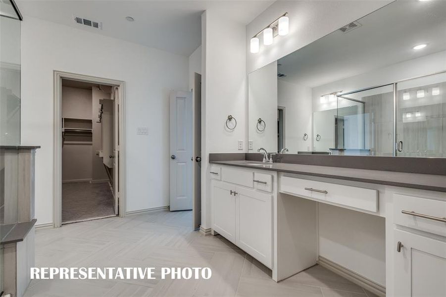 Separate vanities offers everyone their own space in the gorgeous owner's bath.  REPRESENTATIVE PHOTO