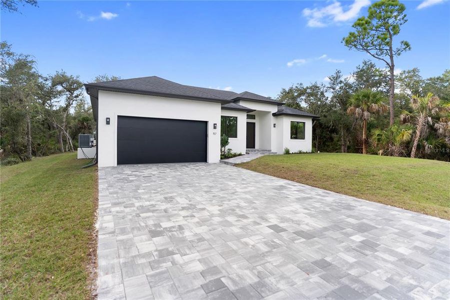 Front exterior of a new home in , Port Charlotte, FL, highlighting curb appeal (Image 2).