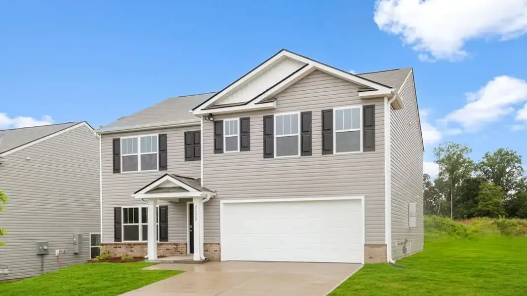 Front exterior of a new home in Ravencrest, Roebuck, SC, highlighting curb appeal (Image 2). Front exterior of a new home in Ravencrest, Roebuck, SC, highlighting curb appeal (Image 2).