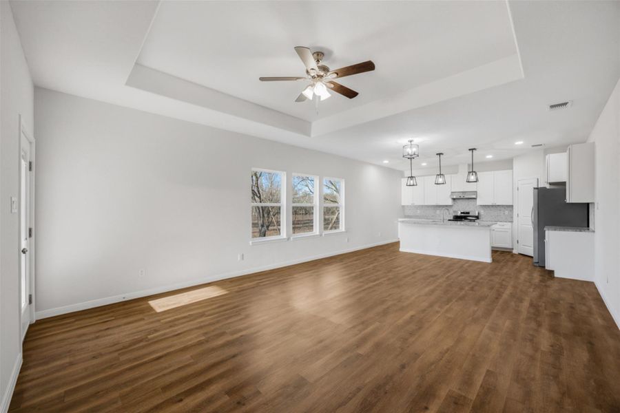 An inviting open floorplan seamlessly connects the living area to a pristine kitchen, ready for memorable moments.