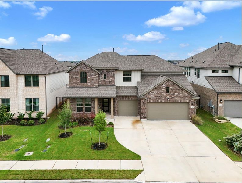 A well-maintained facade presents a welcoming two-story residence with a brick exterior.