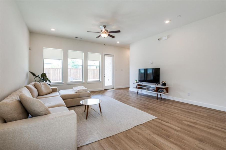 Living area featuring light wood finished floors, recessed lighting, and ceiling fan Living area featuring light wood finished floors, recessed lighting, and ceiling fan
