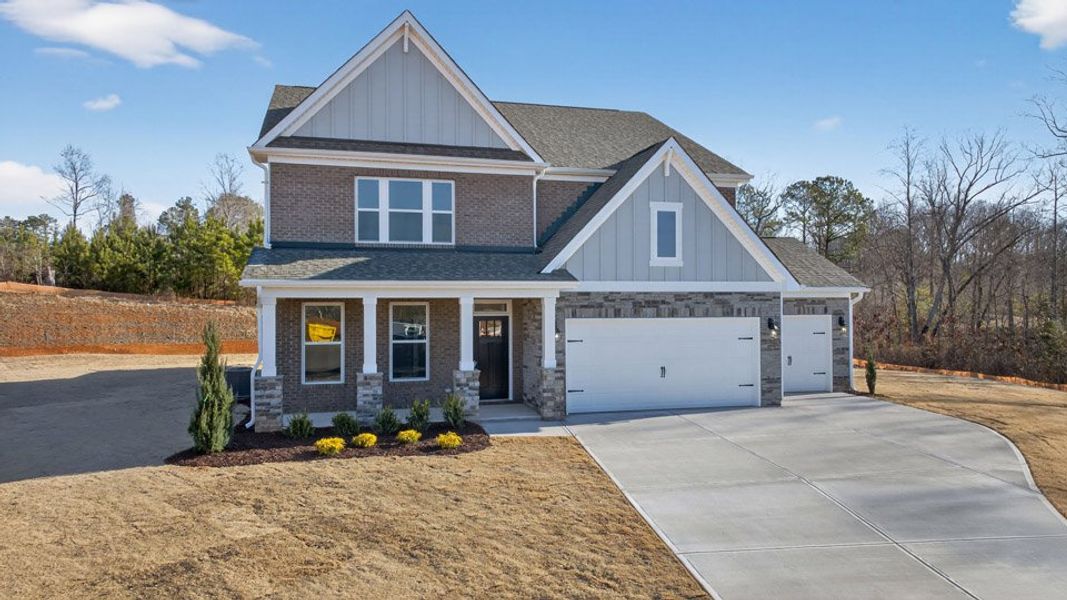 Front exterior of a new home in The Manors at Winston Pointe, Clayton, NC, highlighting curb appeal (Image 19).