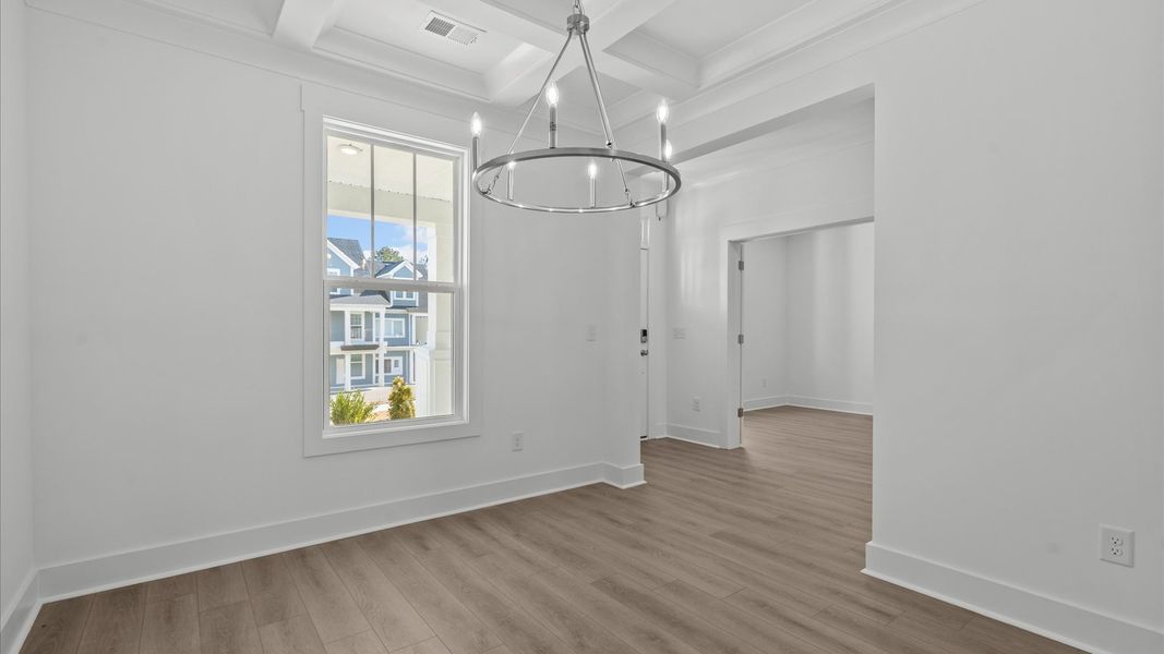 Coffered ceiling detail brings depth and sophistication to this top-notch formal dining room