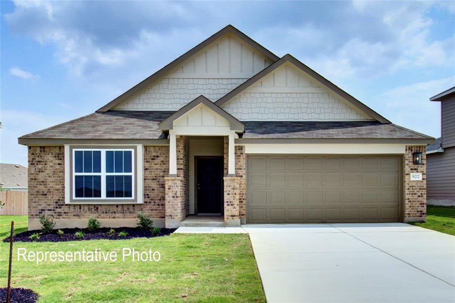 Craftsman inspired home with a garage and a front yard