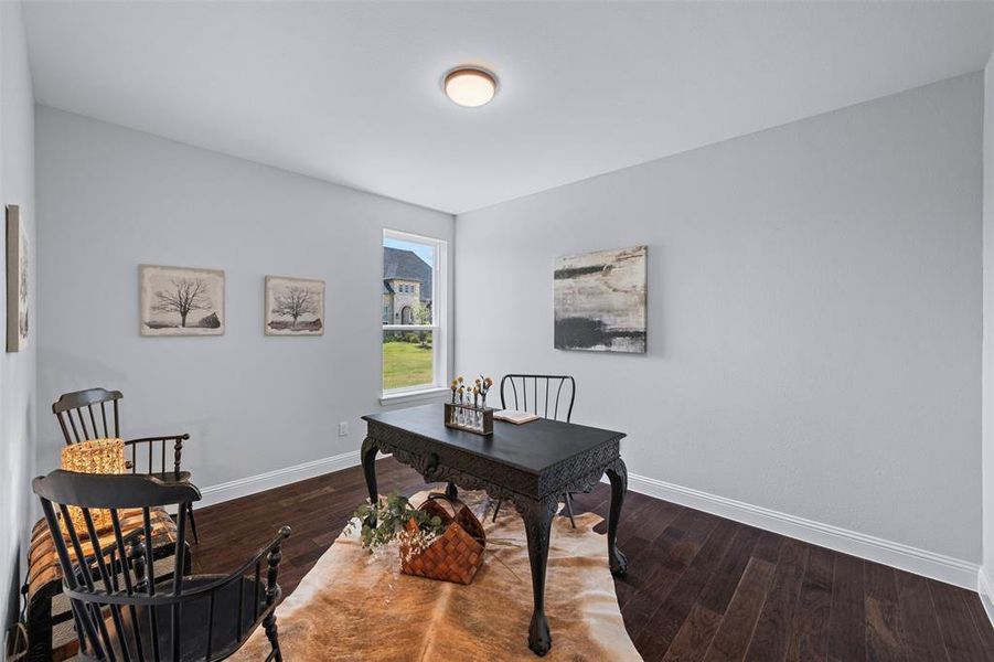 Home office with wood finished floors and baseboards