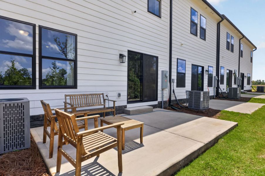 Exterior details and patio area of a home in The Ridge Townhomes, Monroe (Image 2).