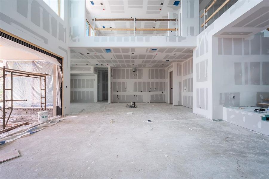 View from primary level living space. Kitchen, dining space, and floor-to-ceiling wine storage.