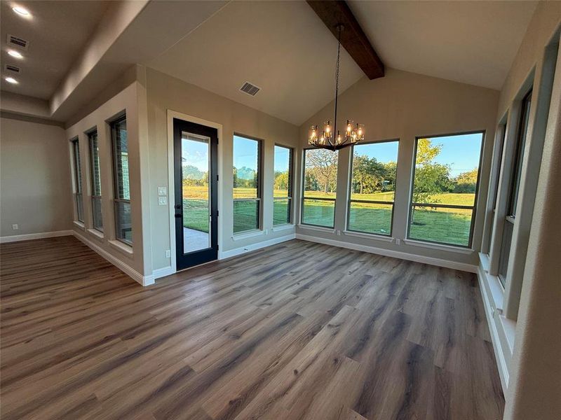 Unfurnished dining area with a chandelier and dark wood-style floors Unfurnished dining area with a chandelier and dark wood-style floors