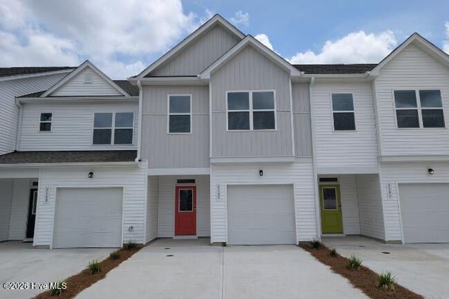 Front exterior of a new home in Coastal Haven Townes, Leland, NC, highlighting curb appeal (Image 1). Front exterior of a new home in Coastal Haven Townes, Leland, NC, highlighting curb appeal (Image 1).